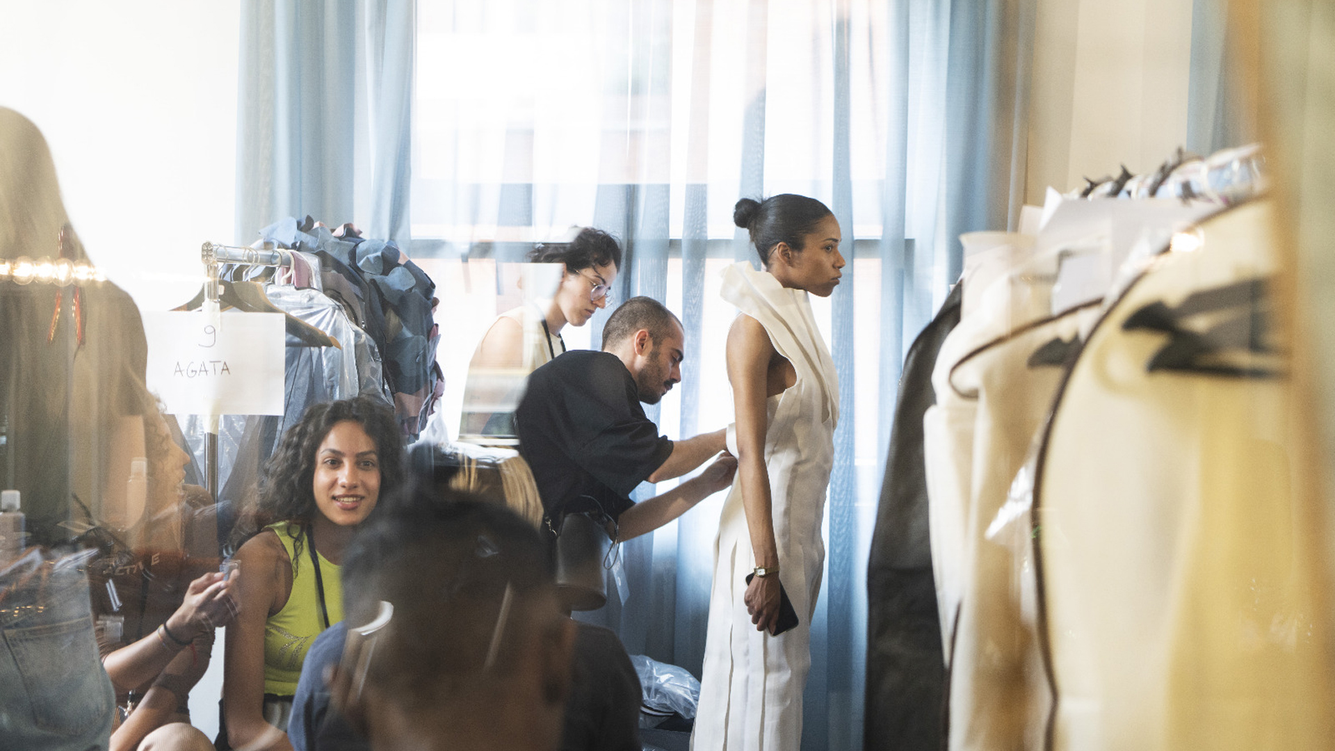 Backstage, designers making the fitting
